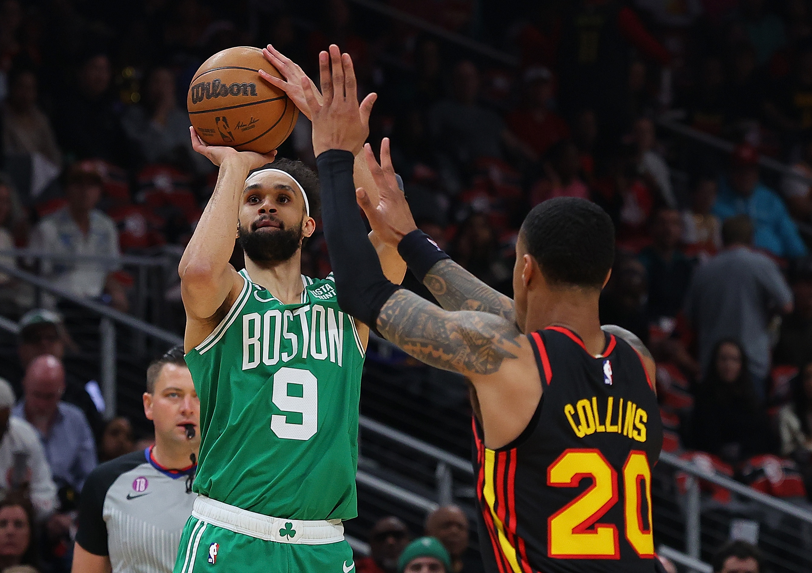 Derrick White of the Boston Celtics attempts a shot against John Collins of the Atlanta Hawks.
