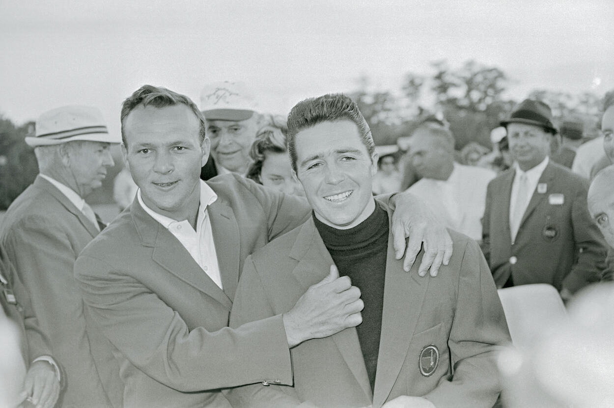 Arnold Palmer places the green jacket on Gary Player's shoulders in 1961.