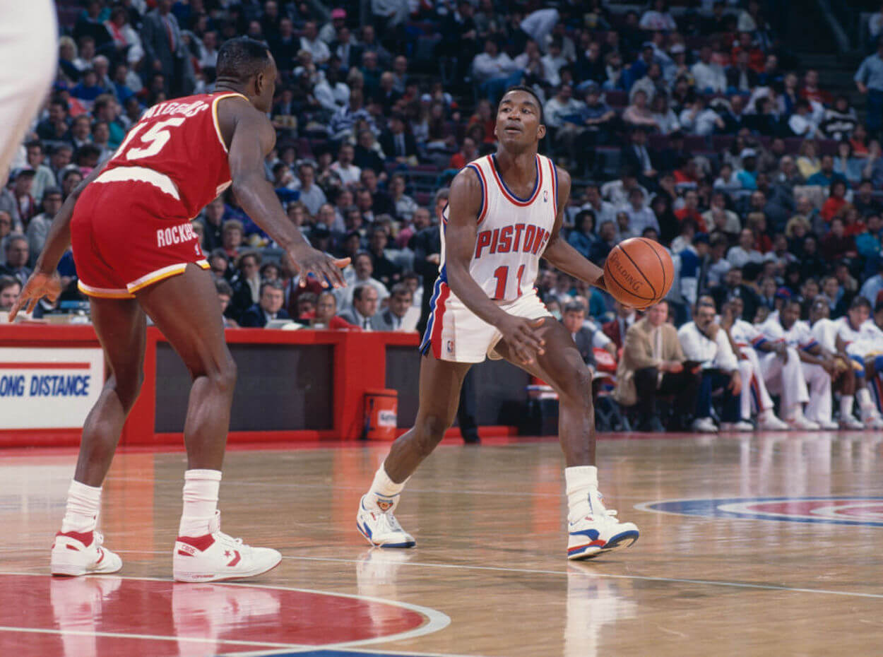 Isiah Thomas (R) dribbles the ball during a Detroit Pistons game.