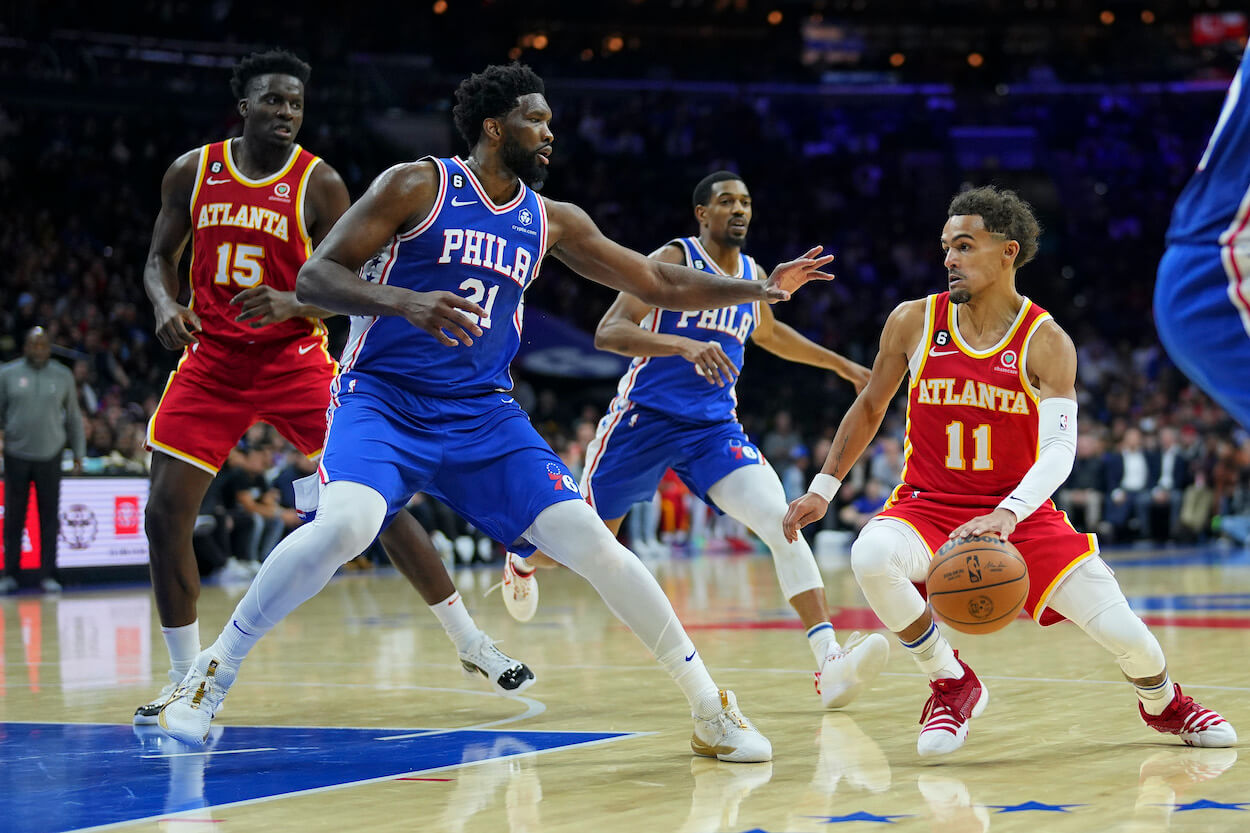 Joel Embiid guards Trae Young.