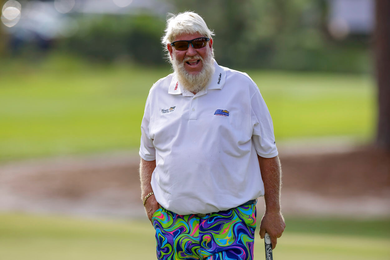 John Daly laughs on the golf course.