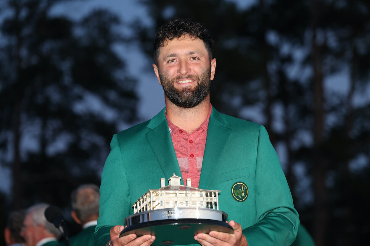 Jon Rahm poses with the green jacket after winning the Masters.