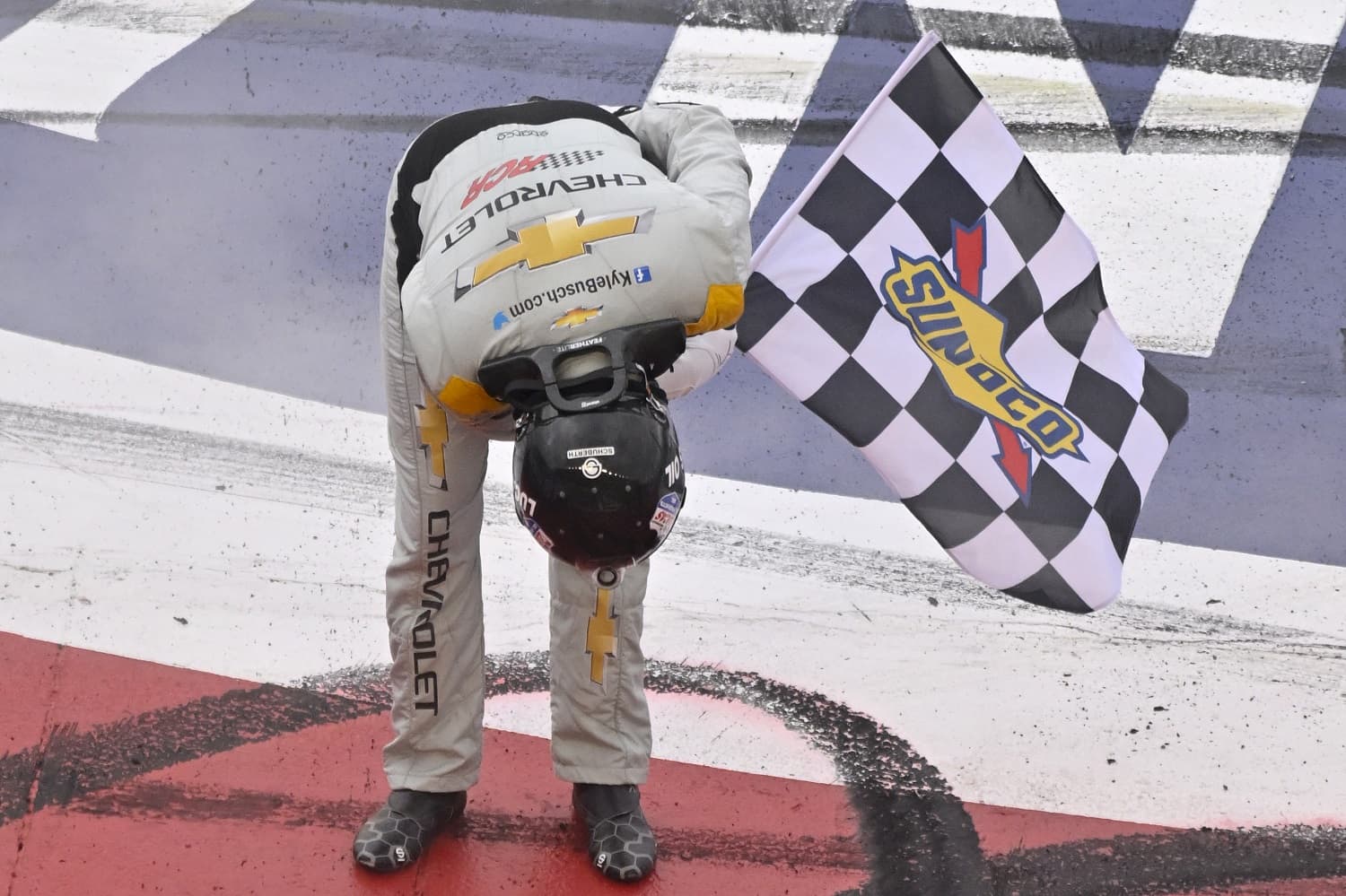 Kyle Busch takes a bow with the checkered flag after winning the NASCAR Cup Series Pala Casino 400 at Auto Club Speedway on Feb. 26, 2023. | Logan Riely/Getty Images