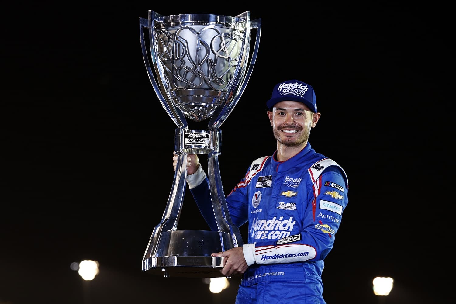 Kyle Larson poses for photos after winning the NASCAR Cup Series Championship at Phoenix Raceway on Nov. 7, 2021.