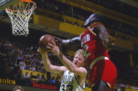 Lewis Lloyd of the Houston Rockets attempts to block the shot of Larry Bird.
