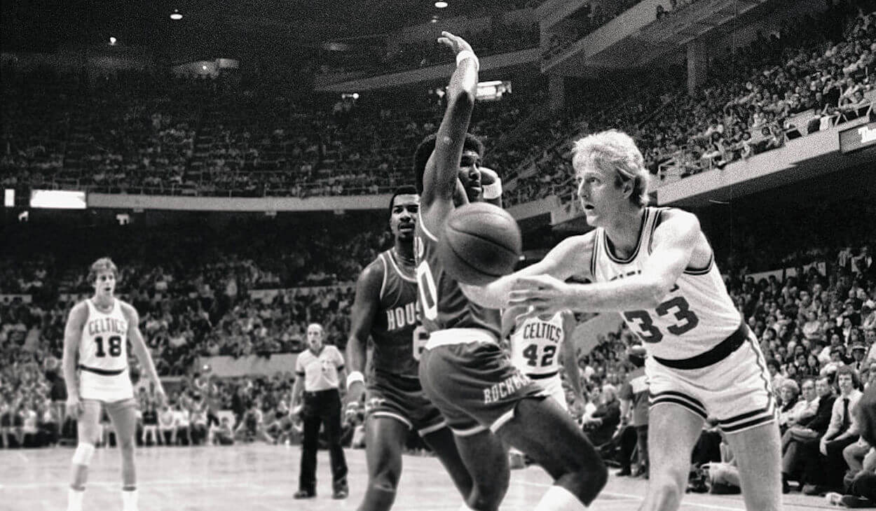 Larry Bird (R) passes the ball during a Boston Celtics game.
