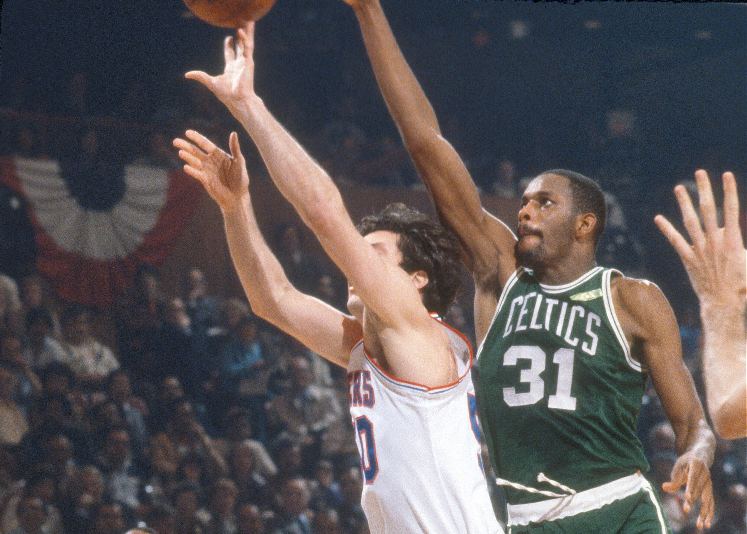 Cedric Maxwell of the Boston Celtics leaps to defend the shot of Steve Mix.