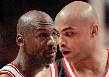 Michael Jordan (L) and Charles Barkley (R) share a few words during a 1998 NBA game.