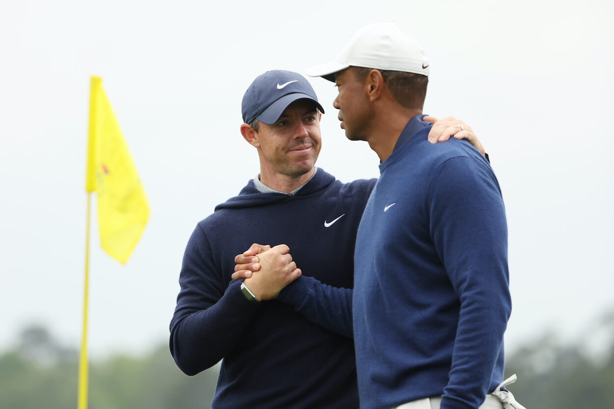 Rory McIlroy and Tiger Woods embrace during a Masters practice round.