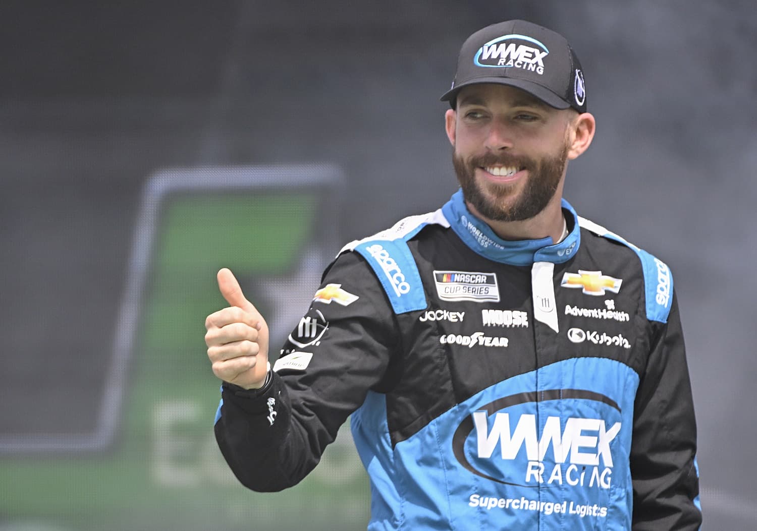 Ross Chastain gives a thumbs-up to fans as he walks onstage during driver intros for the NASCAR Cup Series EchoPark Automotive Grand Prix at Circuit of The Americas on March 26, 2023. | Logan Riely/Getty Images