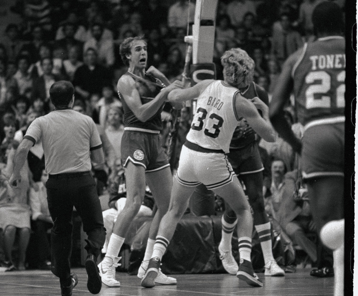 Larry Bird winds up to throw a punch at Marc Iavaroni.