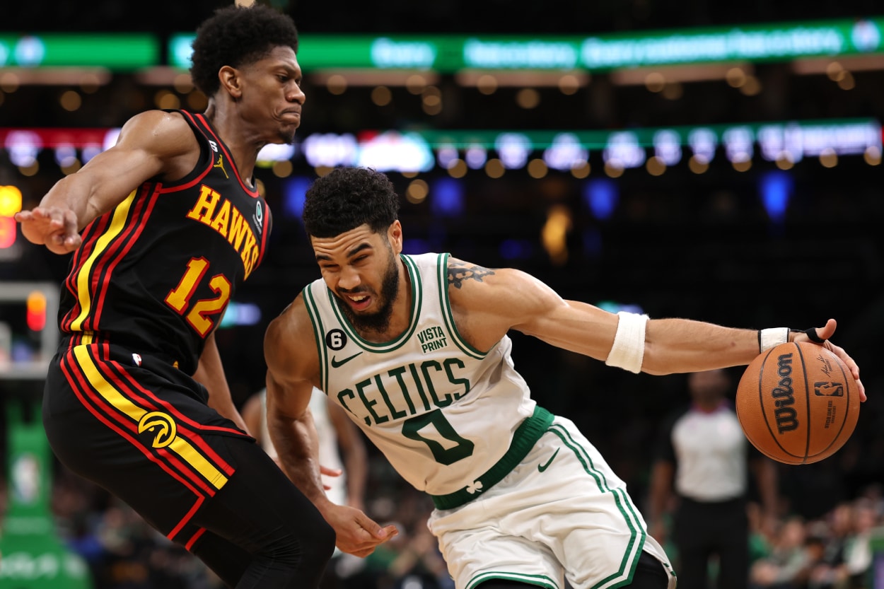 De'Andre Hunter of the Atlanta Hawks defends Jayson Tatum of the Boston Celtics.