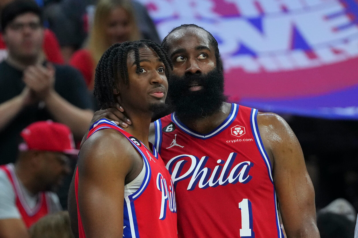 Tyrese Maxey and James Harden look on during a game against the Nets.