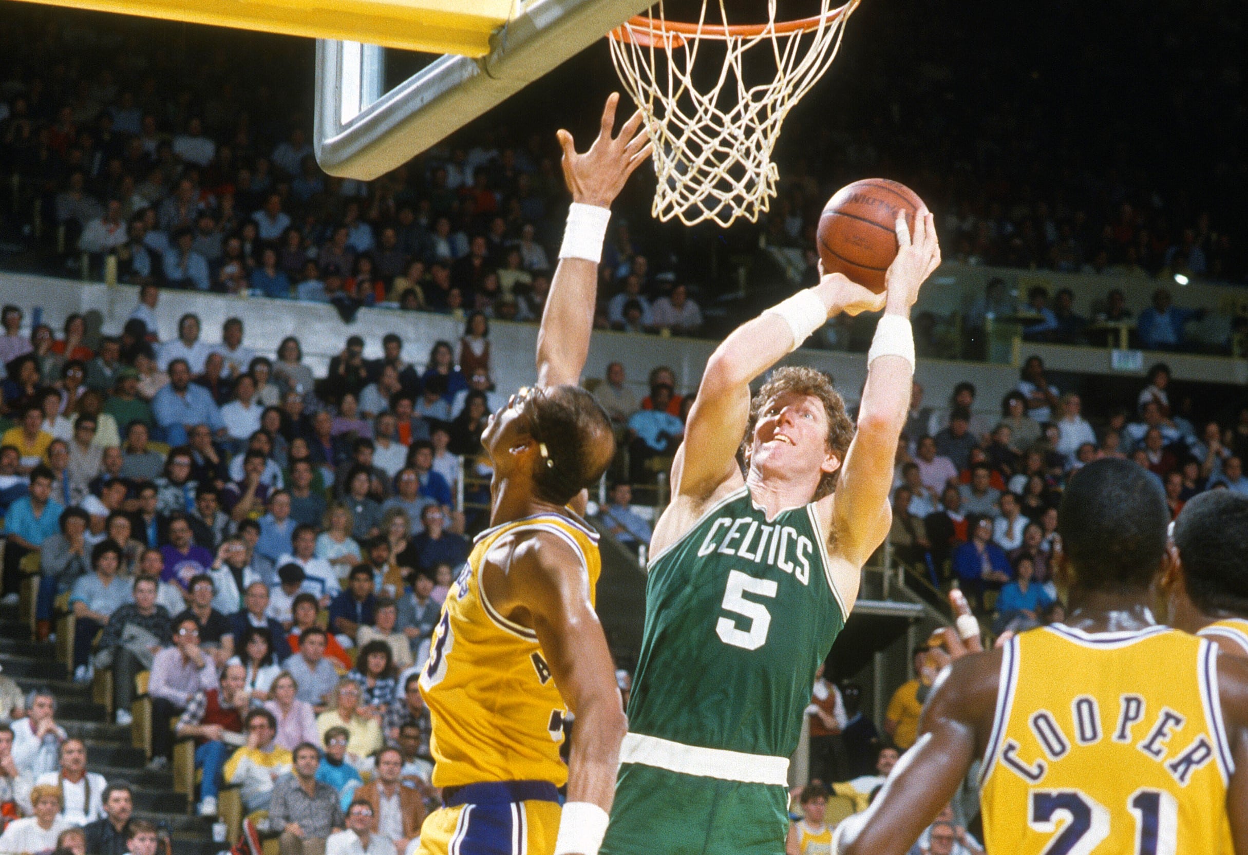 Bill Walton of the Boston Celtics shoots over Kareem Abdul-Jabbar of the Los Angeles Lakers.