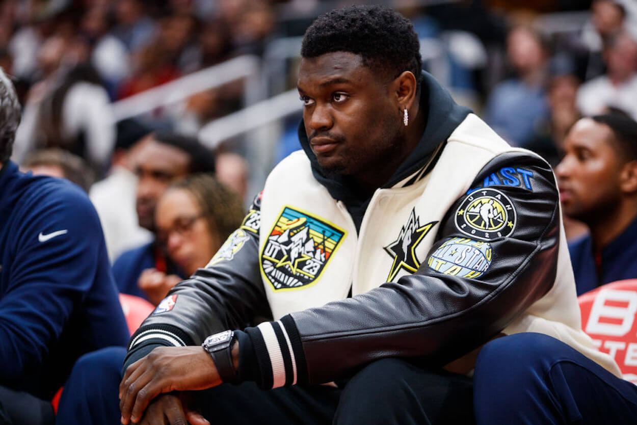Zion Williamson sits on the sidelines during a New Orleans Pelicans game.