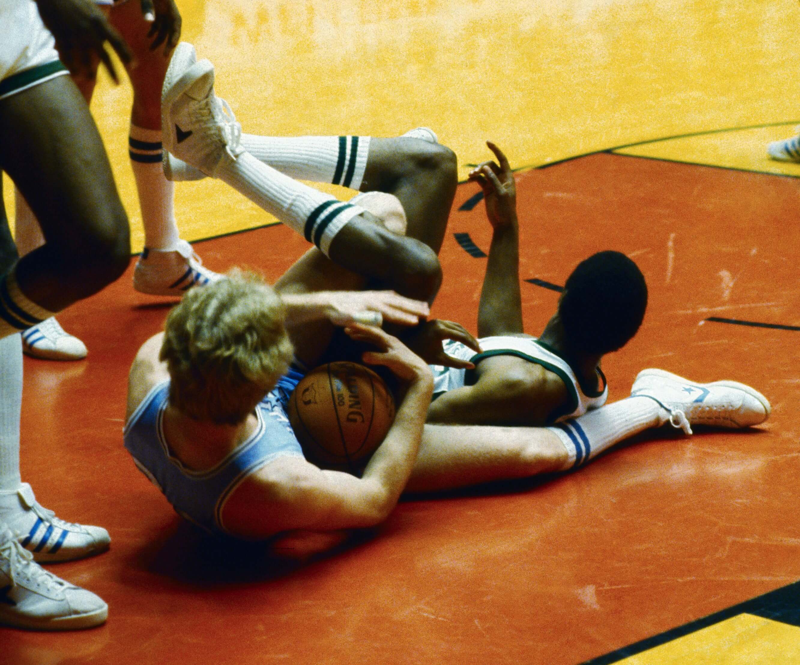 Indiana State's Larry Bird and Michigan State's Earvin Johnson are tangled on the floor.