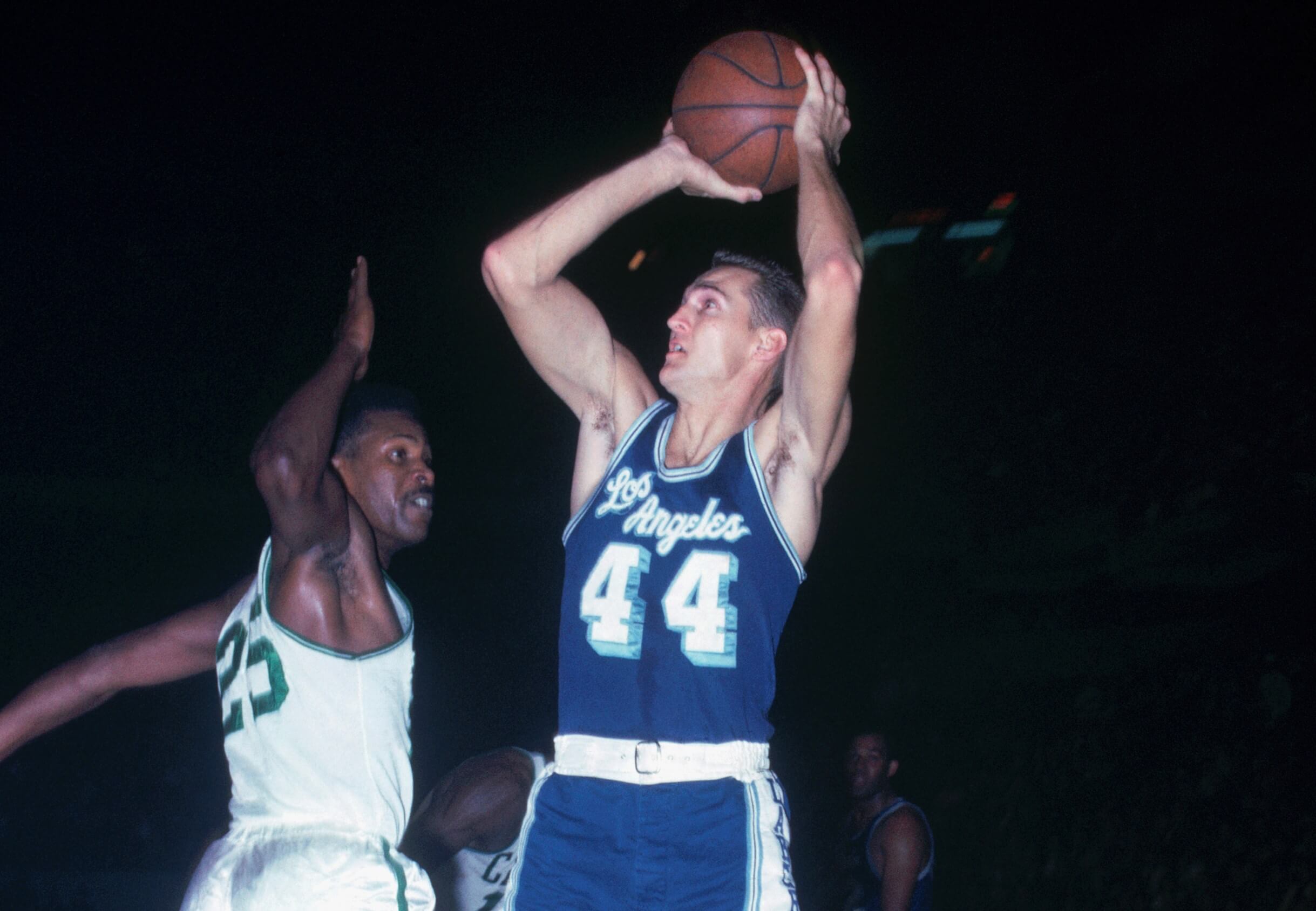 Jerry West of the Los Angeles Lakers shoots a jump shot as K.C. Jones of the Boston Celtics tries for the block.