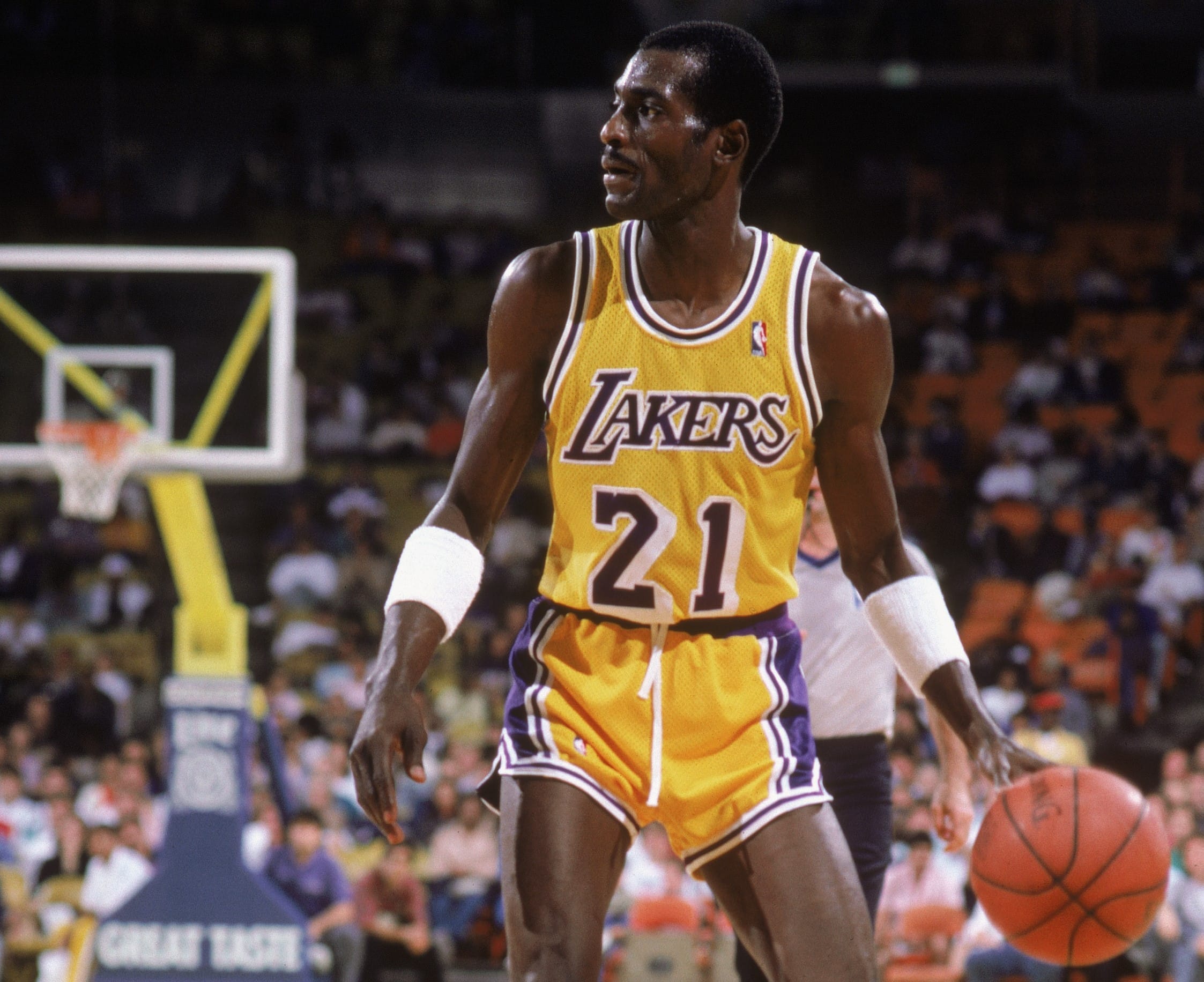 Michael Cooper of the Los Angeles Lakers dribbles the ball.