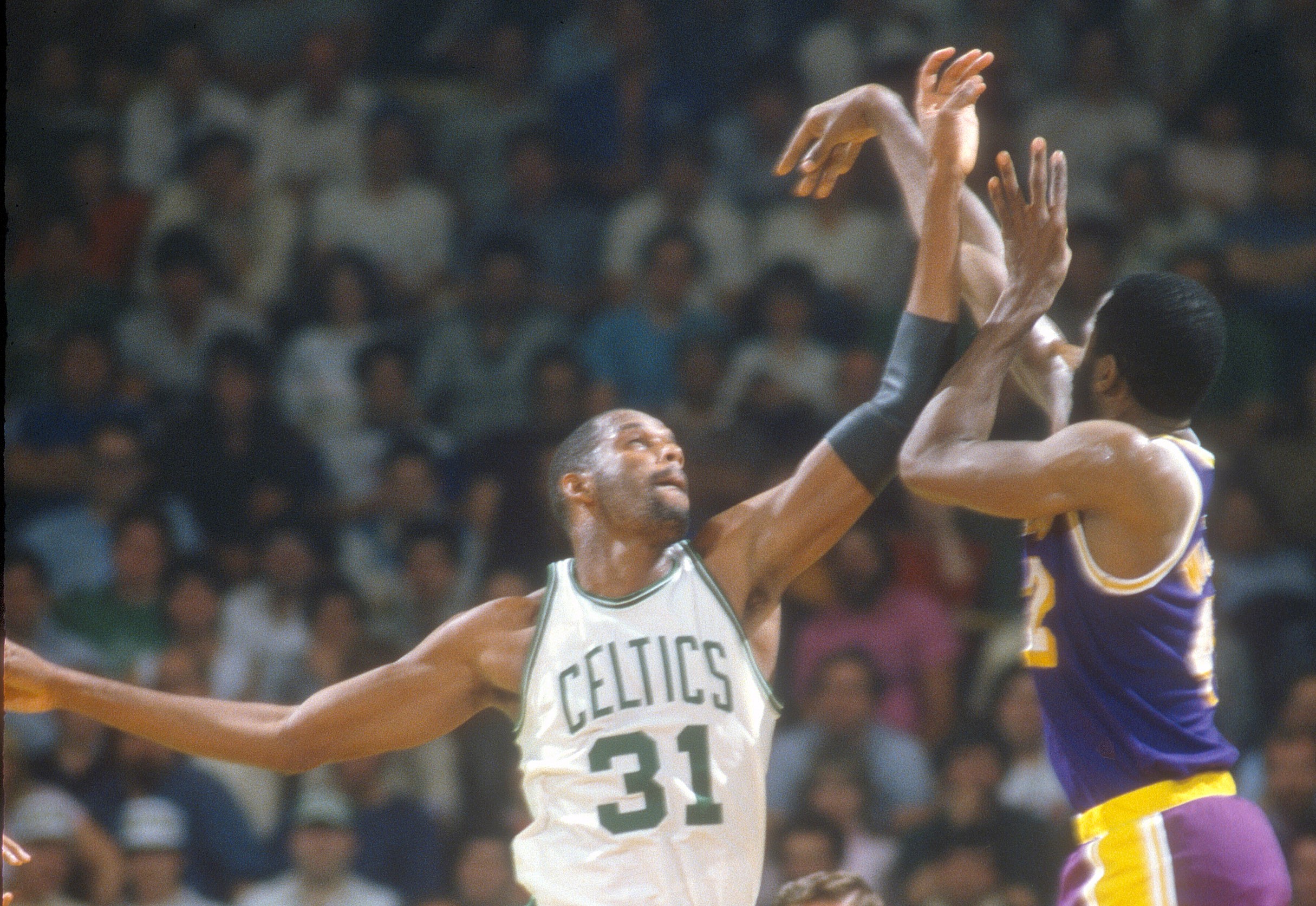James Worthy of the Los Angeles Lakers shoots over Cedric Maxwell of the Boston Celtics