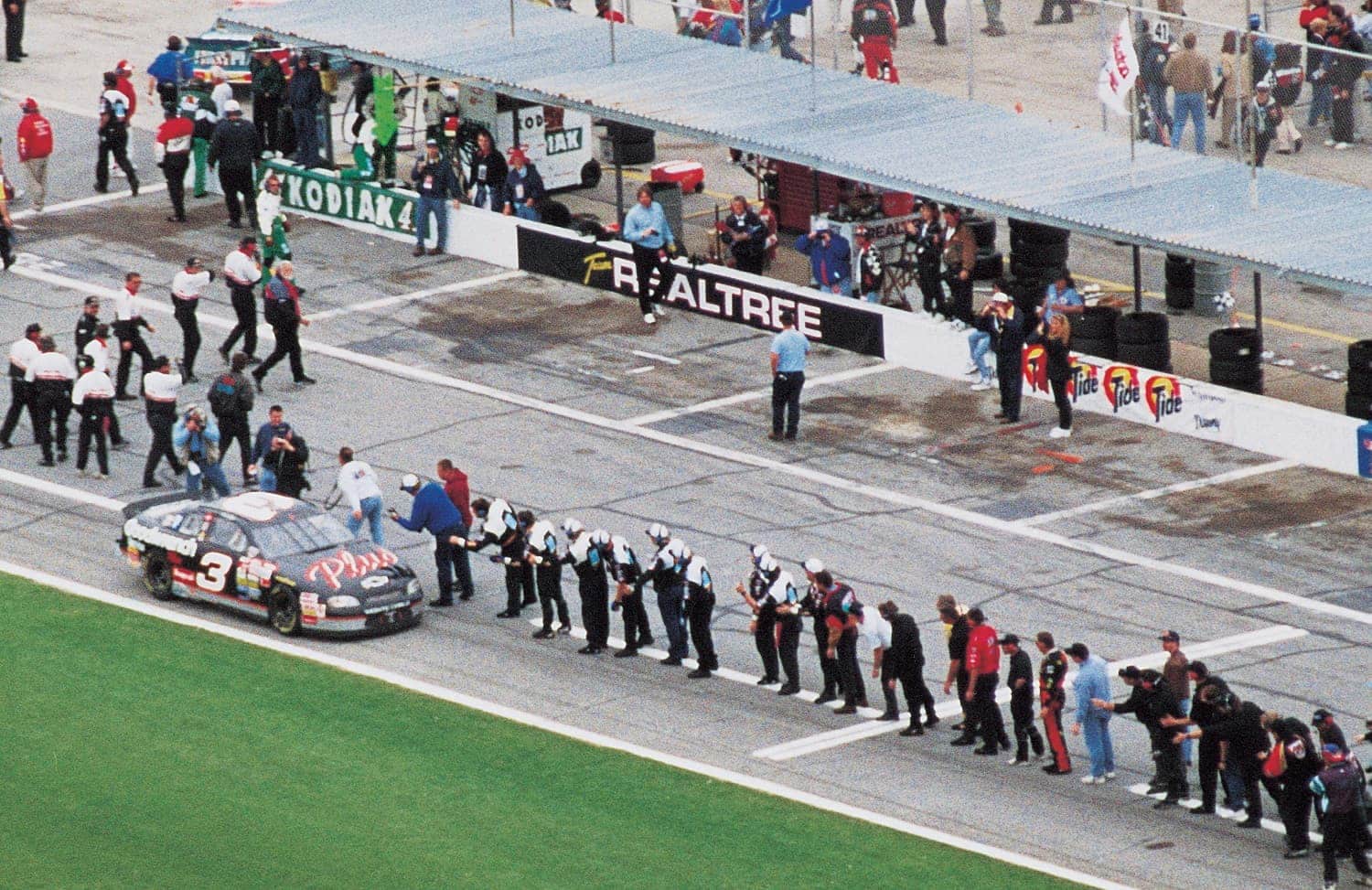 Winner Dale Earnhardt accepts congratulations from crew members of rival teams after scoring his elusive Daytona 500 triumph. | ISC Archives/CQ-Roll Call Group via Getty Images