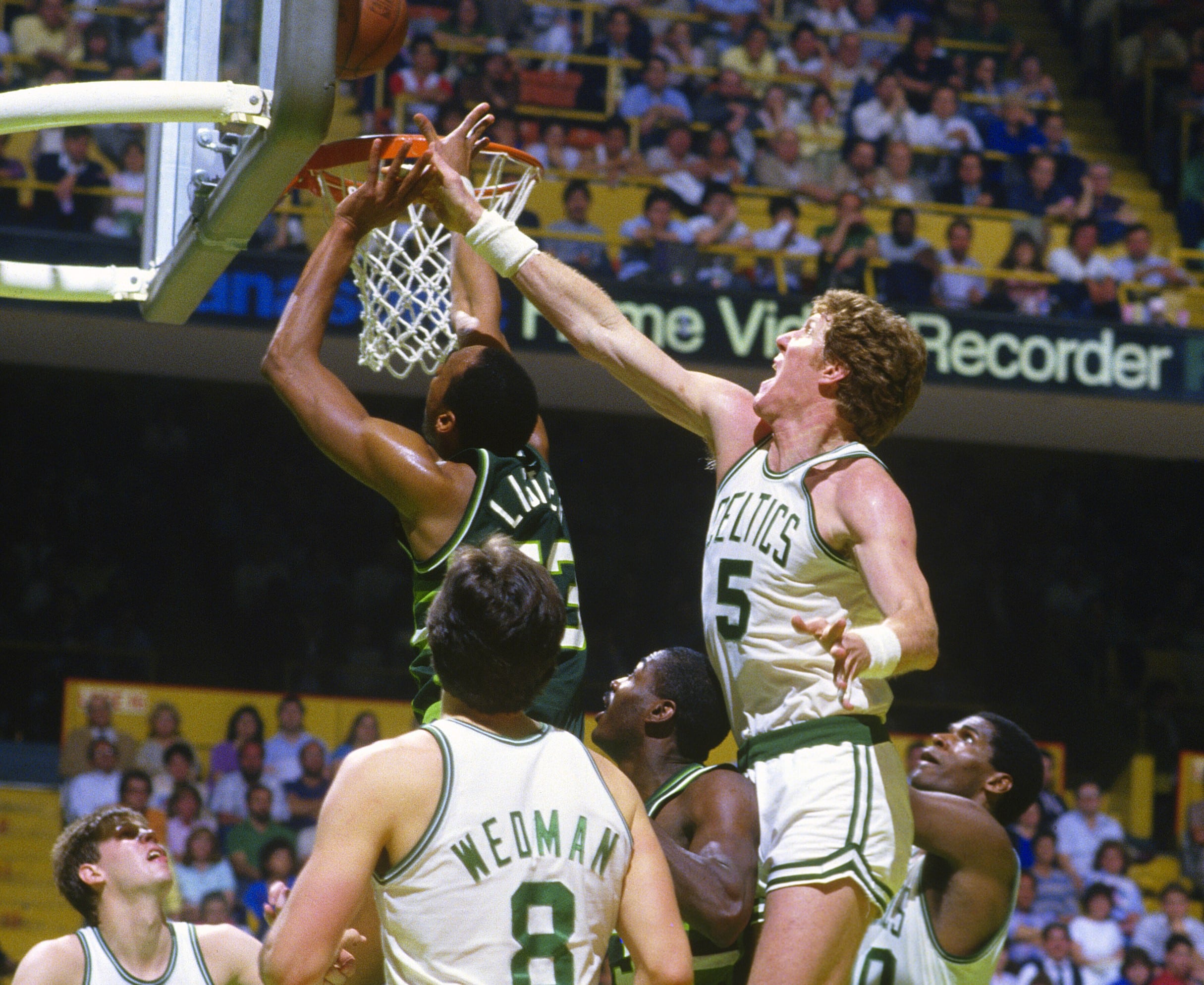 Bill Walton of the Boston Celtics battles for a rebound with Alton Lister of the Milwaukee Bucks.