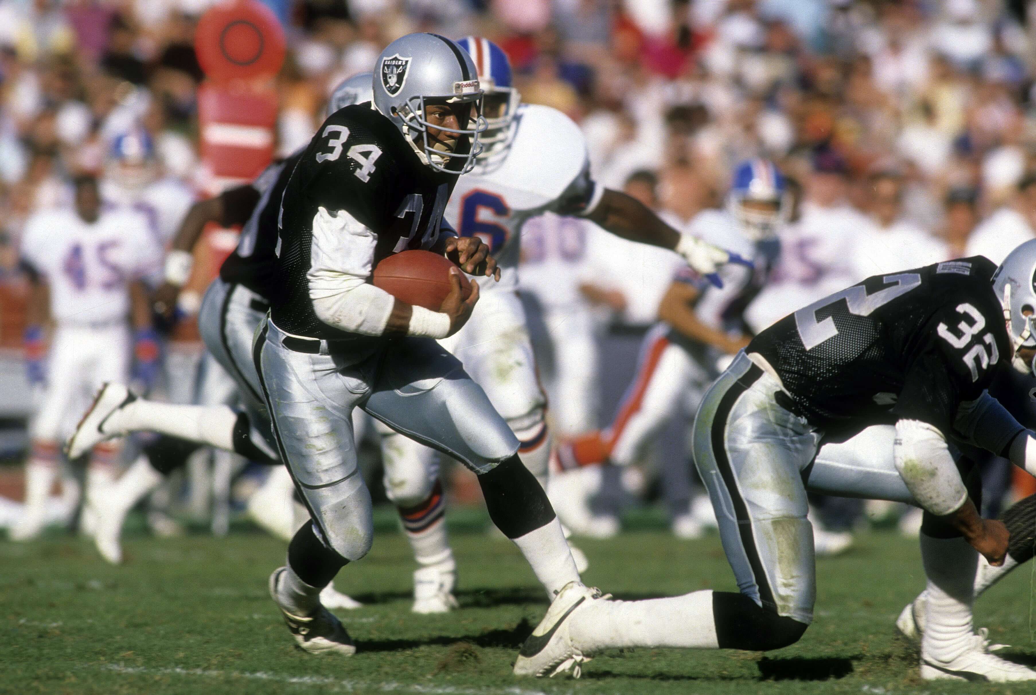 Running back Bo Jackson of the Los Angeles Raiders carries the ball against the Denver Broncos.