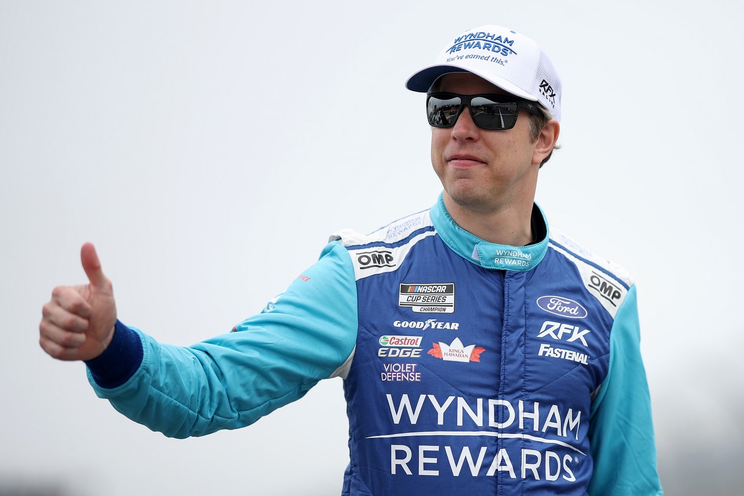 Brad Keselowski gives a thumbs-up as he walks the grid during practice for the NASCAR Cup Series Würth 400 at Dover International Speedway on April 29, 2023.