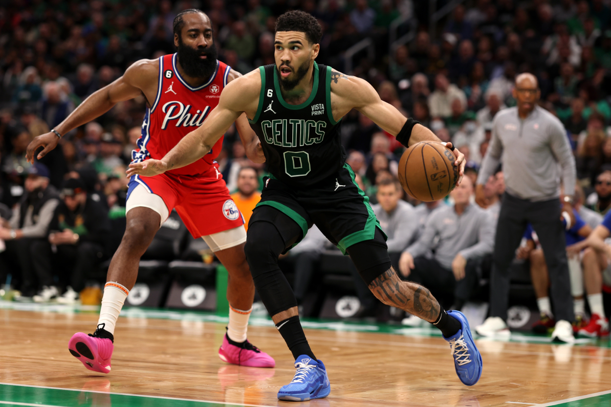 James Harden of the Philadelphia 76ers defends Jayson Tatum of the Boston Celtics.