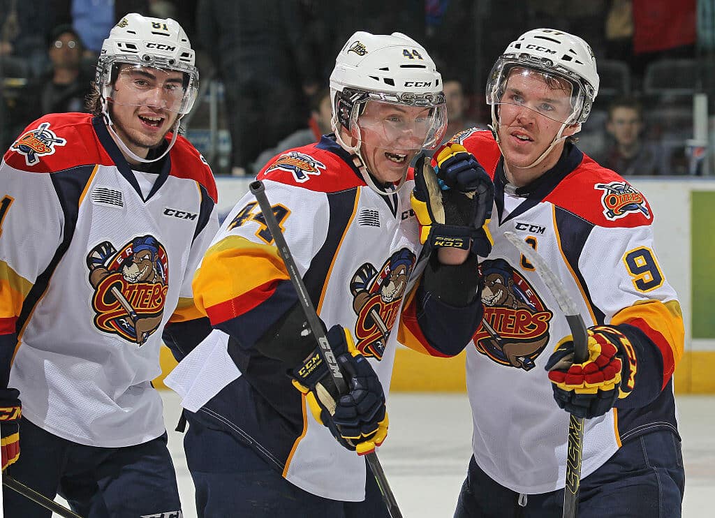 Connor McDavid (R) and Travis Dermott (C) celebrate together during 2015 with the Erie Otters.