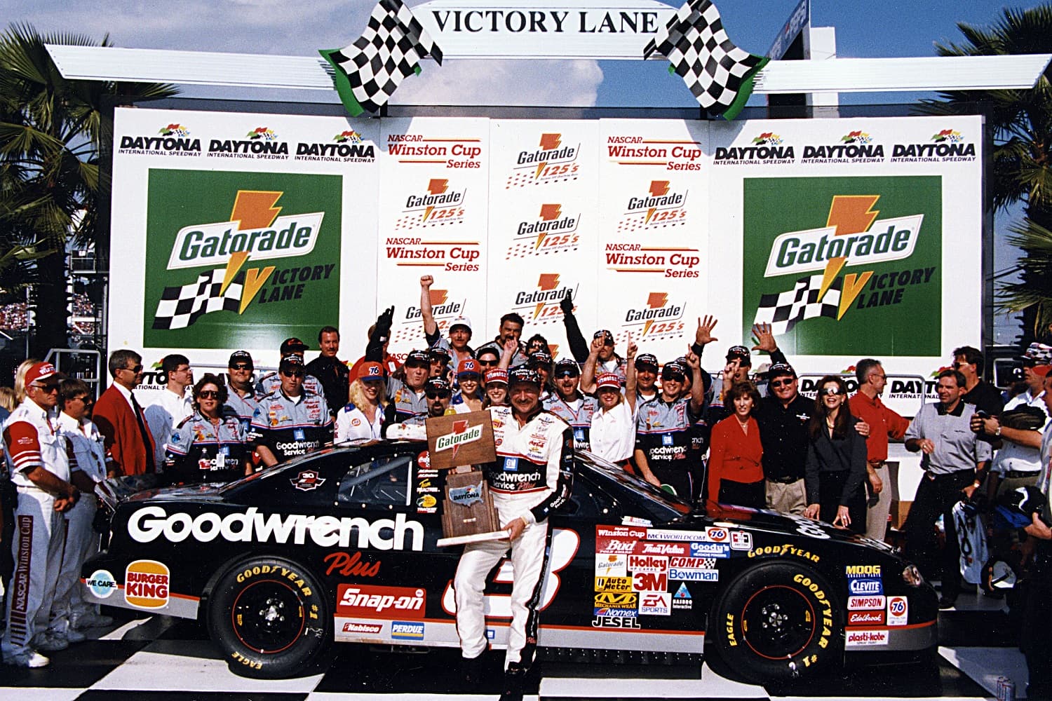 Dale Earnhardt and his crew celebrate at Daytona International Speedway after a win in one of the Gatorade 125 qualifying races for the 1997 Daytona 500.