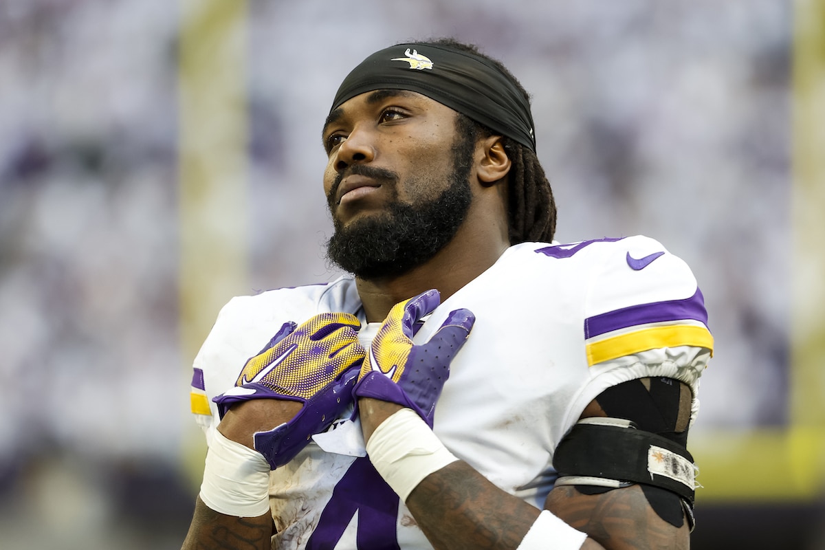 Minnesota Vikings running back Dalvin Cook grabs his pads without a helmet