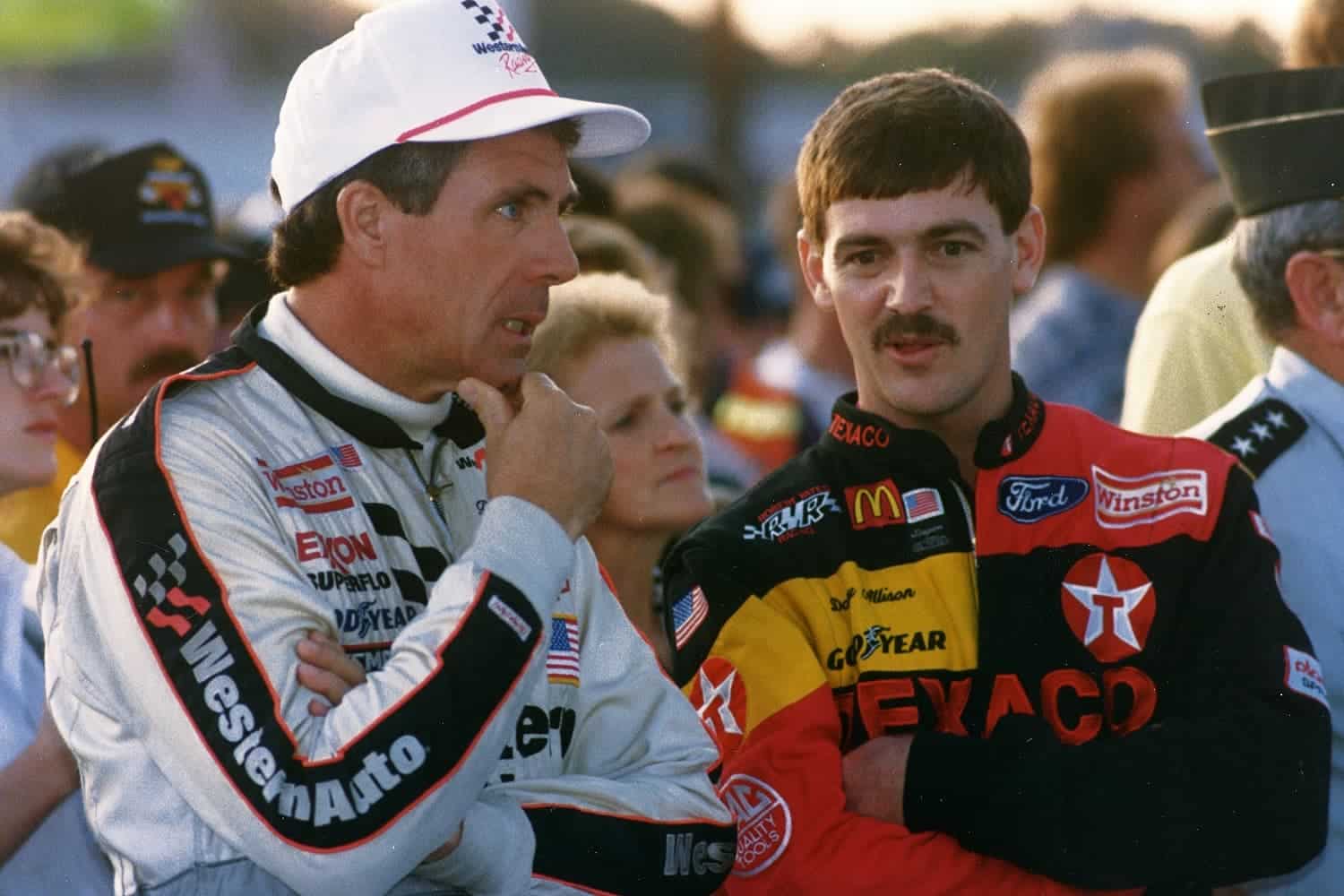 Darrell Waltrip talks with Davey Allison before the 1992 Miller Genuine Draft 400 at Richmond International Raceway. | ISC Images and Archives via Getty Images