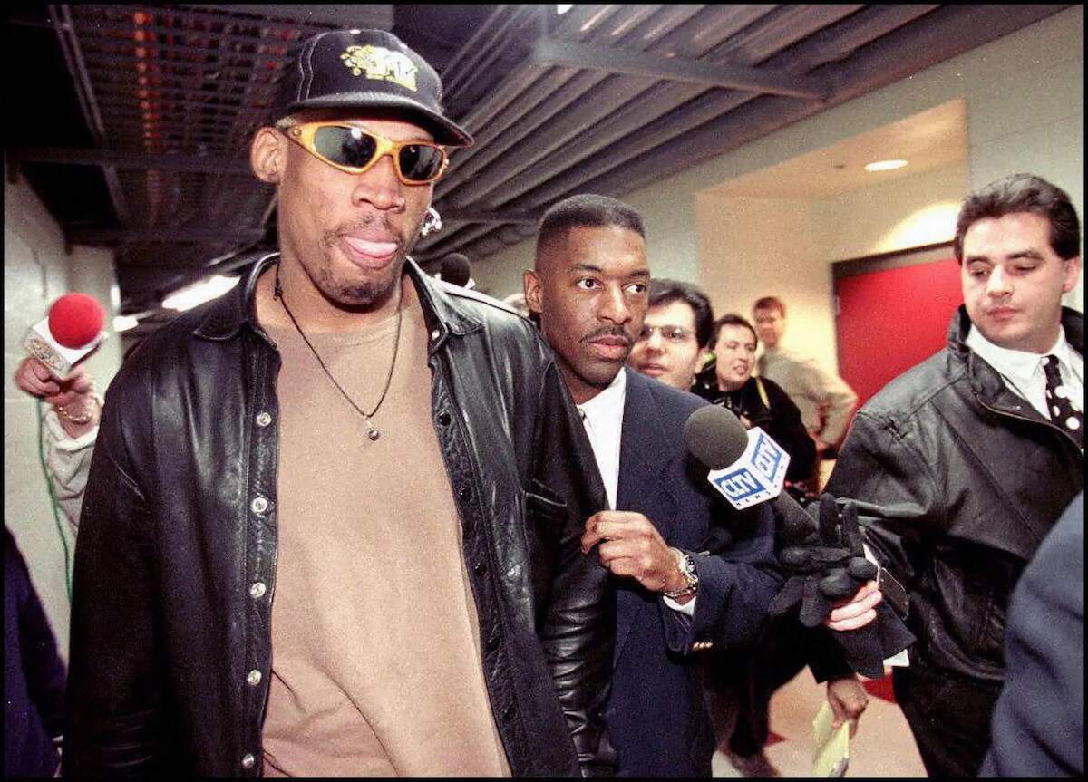 Chicago Bulls star Dennis Rodman exits the Bulls stadium amongst journalists