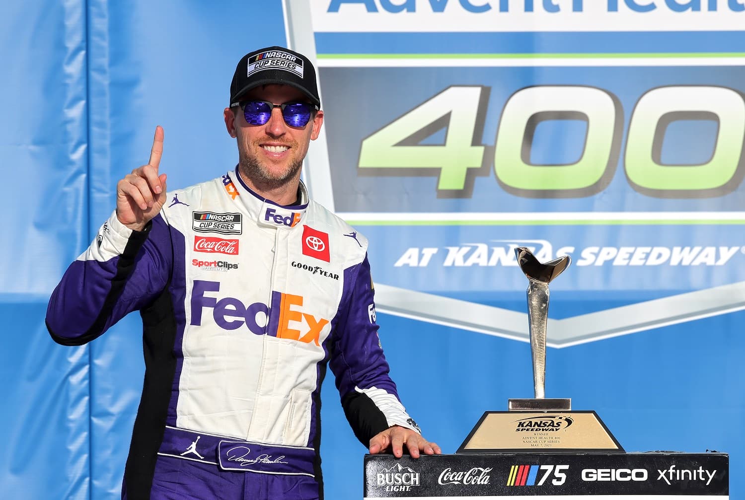 Denny Hamlin celebrates after the NASCAR Cup Series Advent Health 400 at Kansas Speedway on May 7, 2023. | Jonathan Bachman/Getty Images