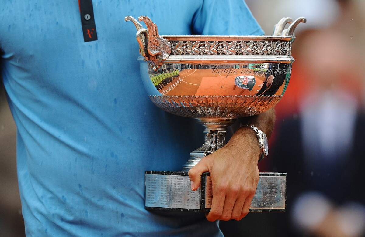Roger Federer holds the French Open trophy after winning