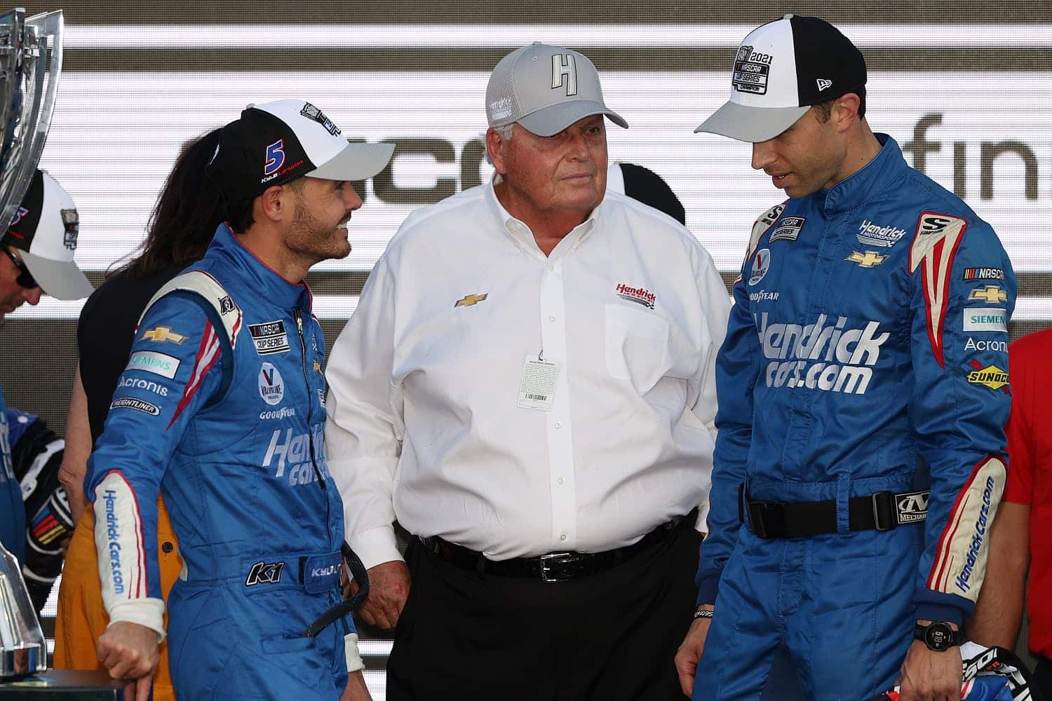 Kyle Larson, Rick Hendrick, an Cliff Daniels talk in victory lane after winning the NASCAR Cup Series Championship at Phoenix Raceway on Nov. 7, 2021.