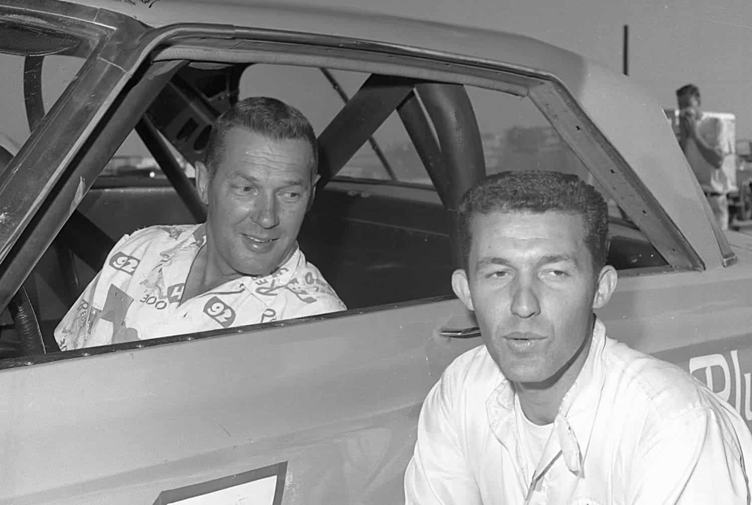 Jim Paschal (in car) and Richard Petty pose for a photo during the 1965 NASCAR season. Petty Enterprises hired Paschal to drive in three races, and he responded by finishing no worse than fifth.