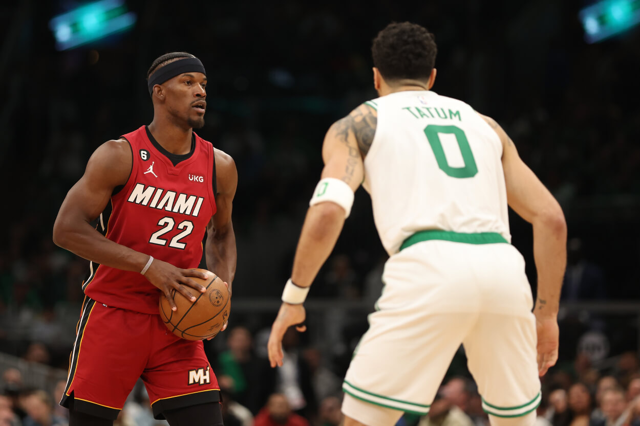 Jimmy Butler of the Miami Heat is defended by Jayson Tatum of the Boston Celtics.