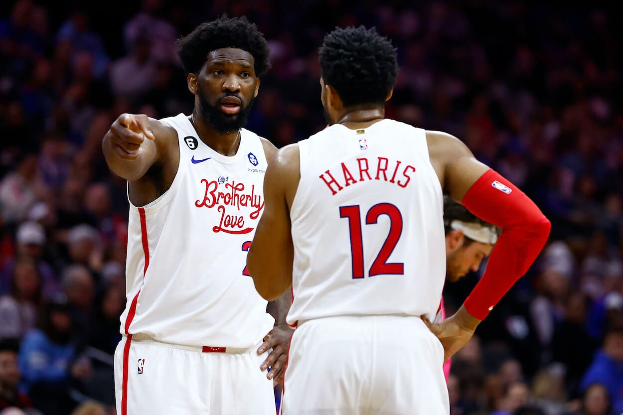 Joel Embiid and Tobias Harris argue on the court.