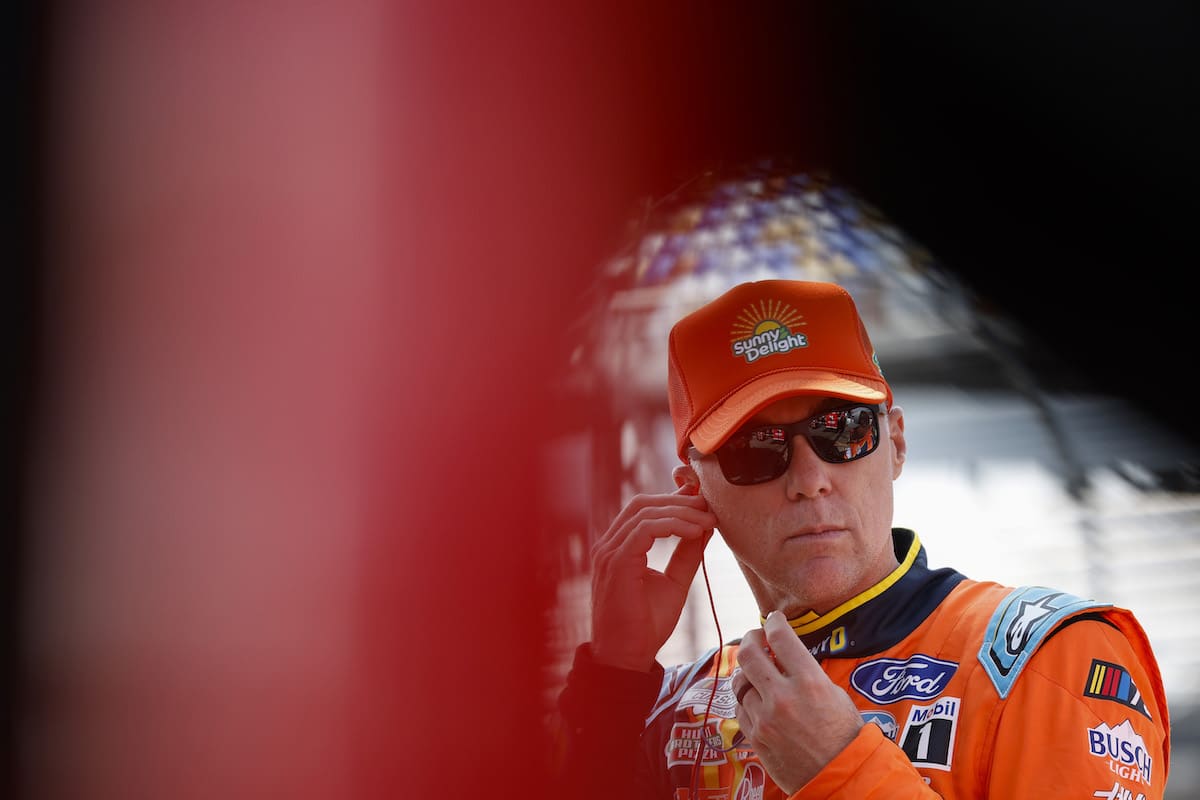 Kevin Harvick adjusts an earpiece