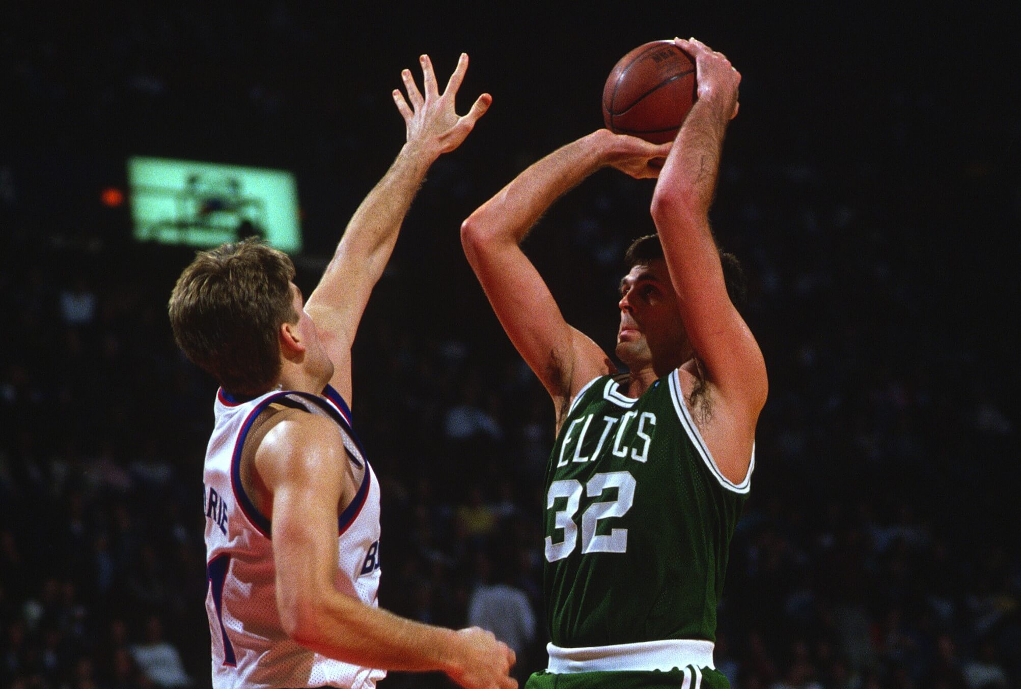 Kevin McHale of the Boston Celtics shoots over Mark Alarie of the Washington Bullets.
