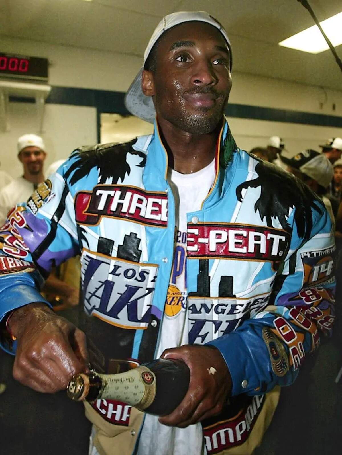 Lakers player Kobe Bryant opens a bottle of champagne