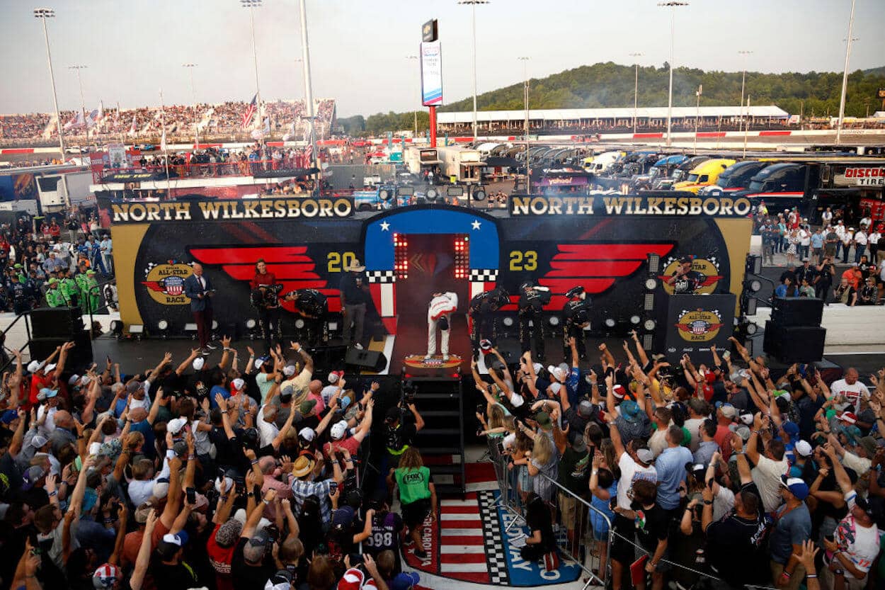 Kyle Busch (center) bows for the crowd during driver introductions at the 2023 NASCAR All-Star Race.