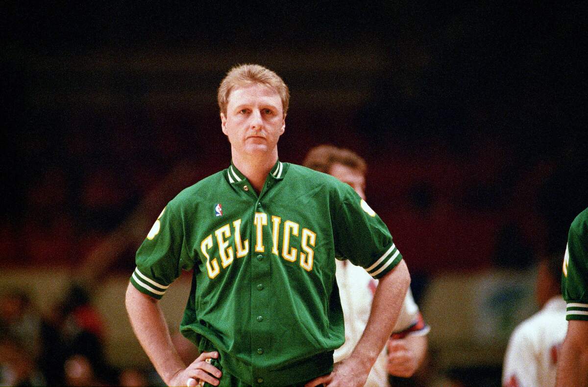 Former Boston Celtics forward Larry Bird reacts to a play during an NBA game