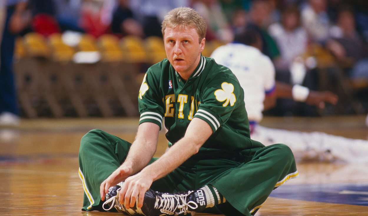 Larry Bird stretches before a game with the Boston Celtics.