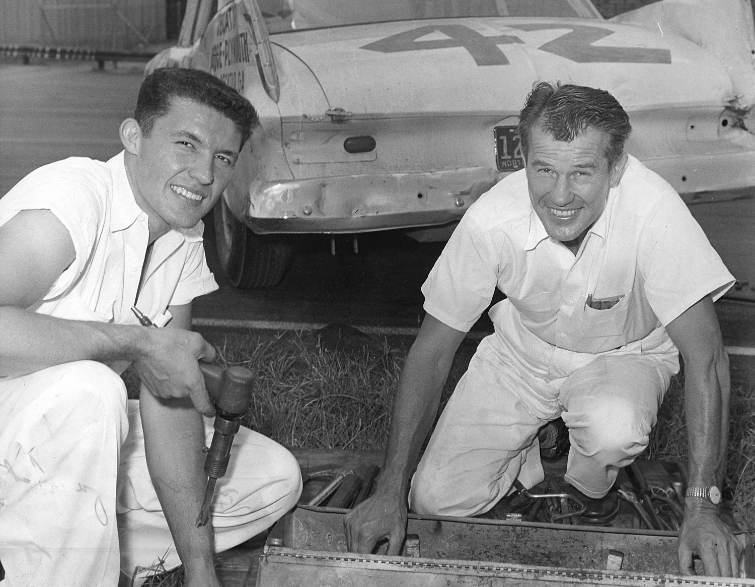 Richard Petty and his father, Lee Petty, take a break for a photo at a NASCAR Cup event in 1959.