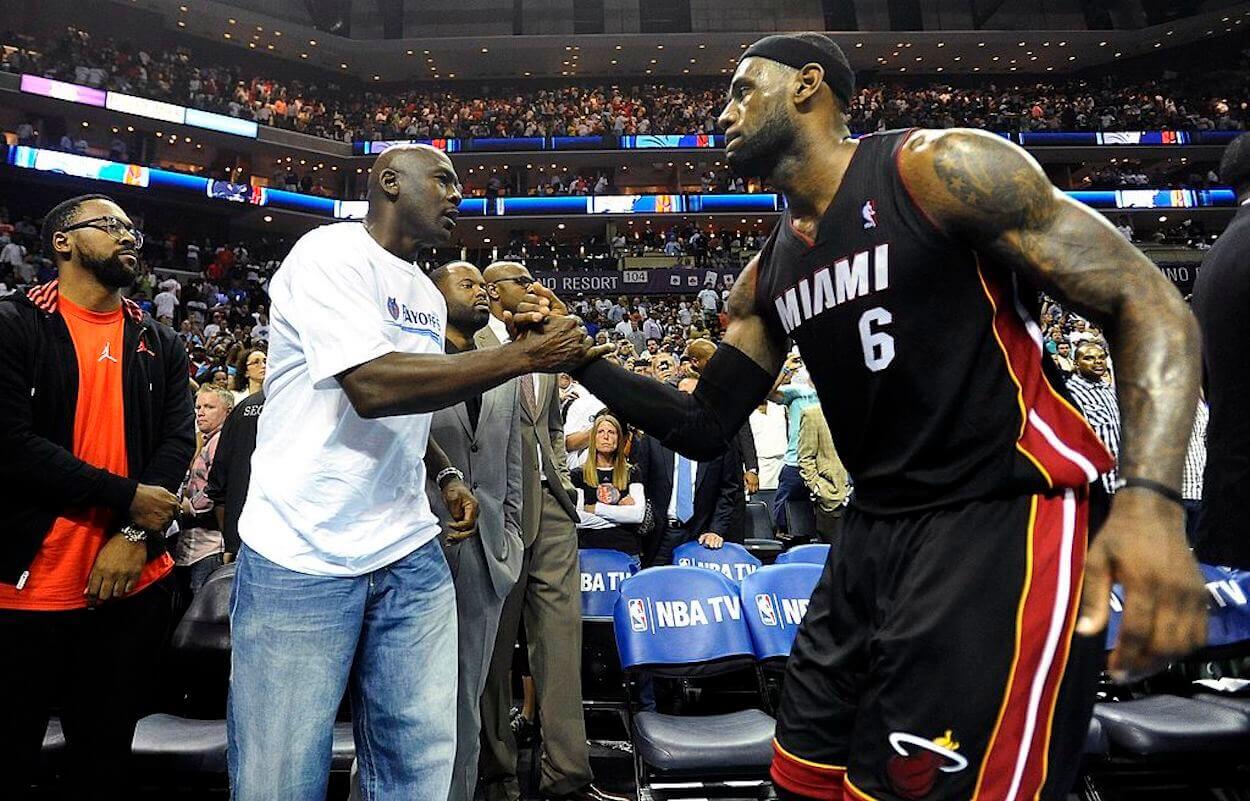 Michael Jordan (L) and LeBron James (R) shake hands.