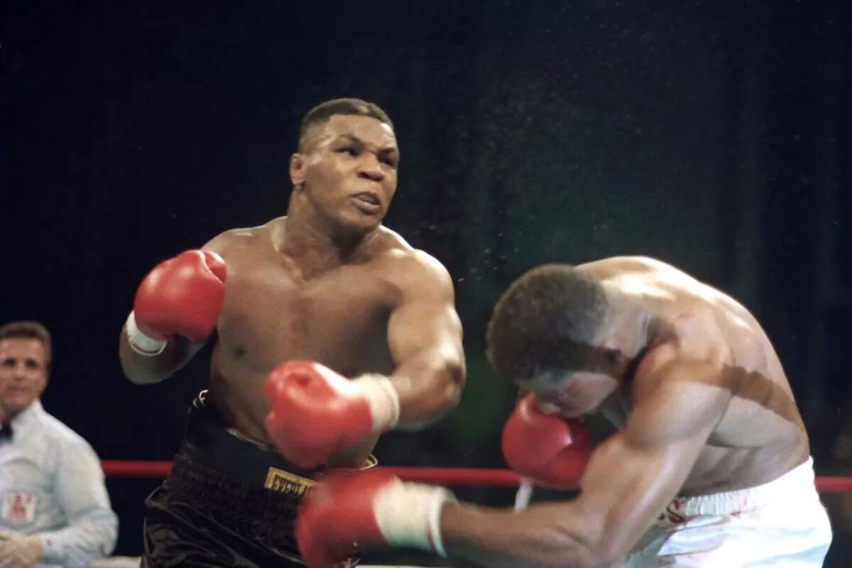 Boxer Mike Tyson knocks Tyrell Biggs to the canvas in 1987