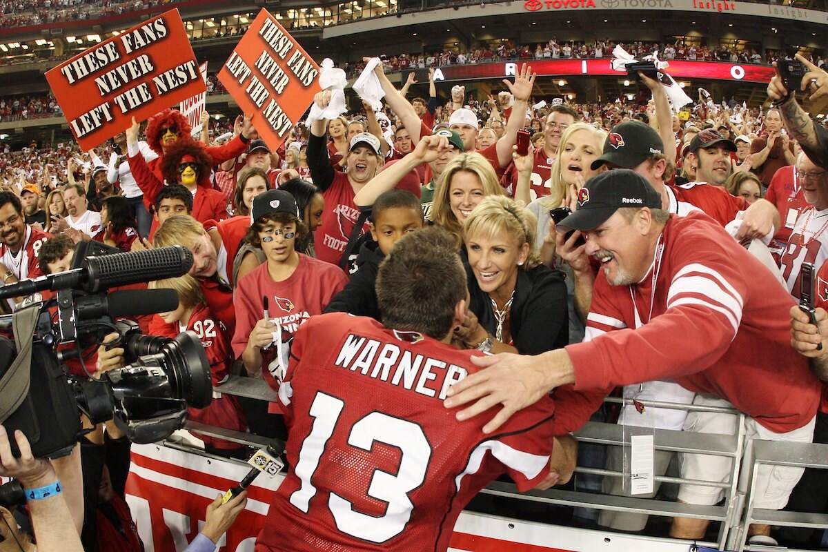 Arizona Cardinals quarterback Kurt Warner embraces his wife Brenda Warner after a wild card playoff win against the Green Bay Packers in 2010