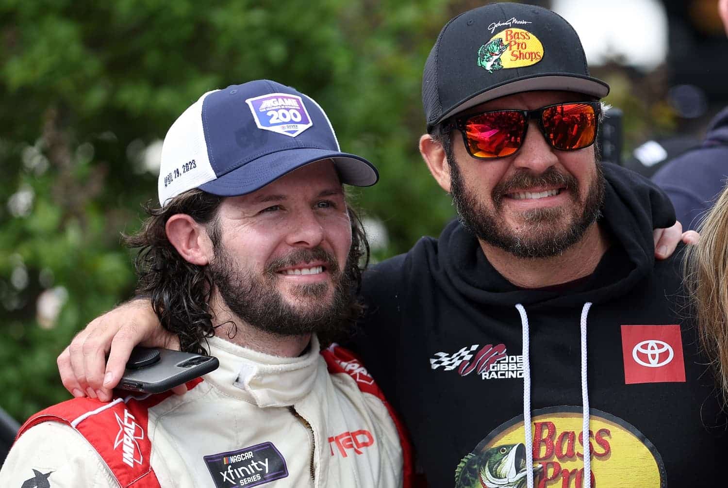 Ryan Truex celebrates with NASCAR Series Cup driver Martin Truex Jr. after winning the Xfinity Series A-GAME 200 at Dover International Speedway on April 29, 2023.